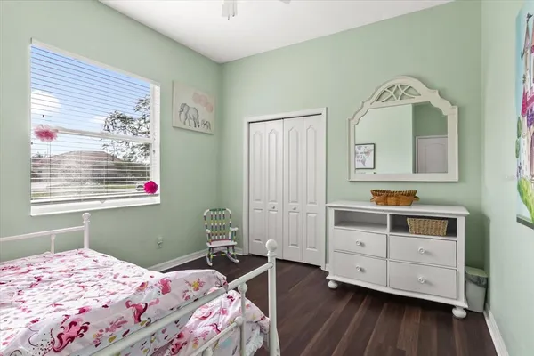 a bedroom with a bed and a dresser