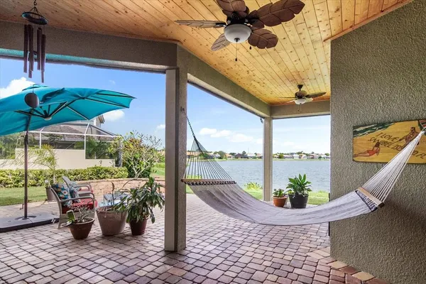 a view of a balcony with chair and potted plants