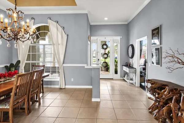 a view of a dining room with furniture and chandelier