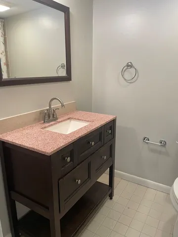 a bathroom with a sink vanity and a mirror