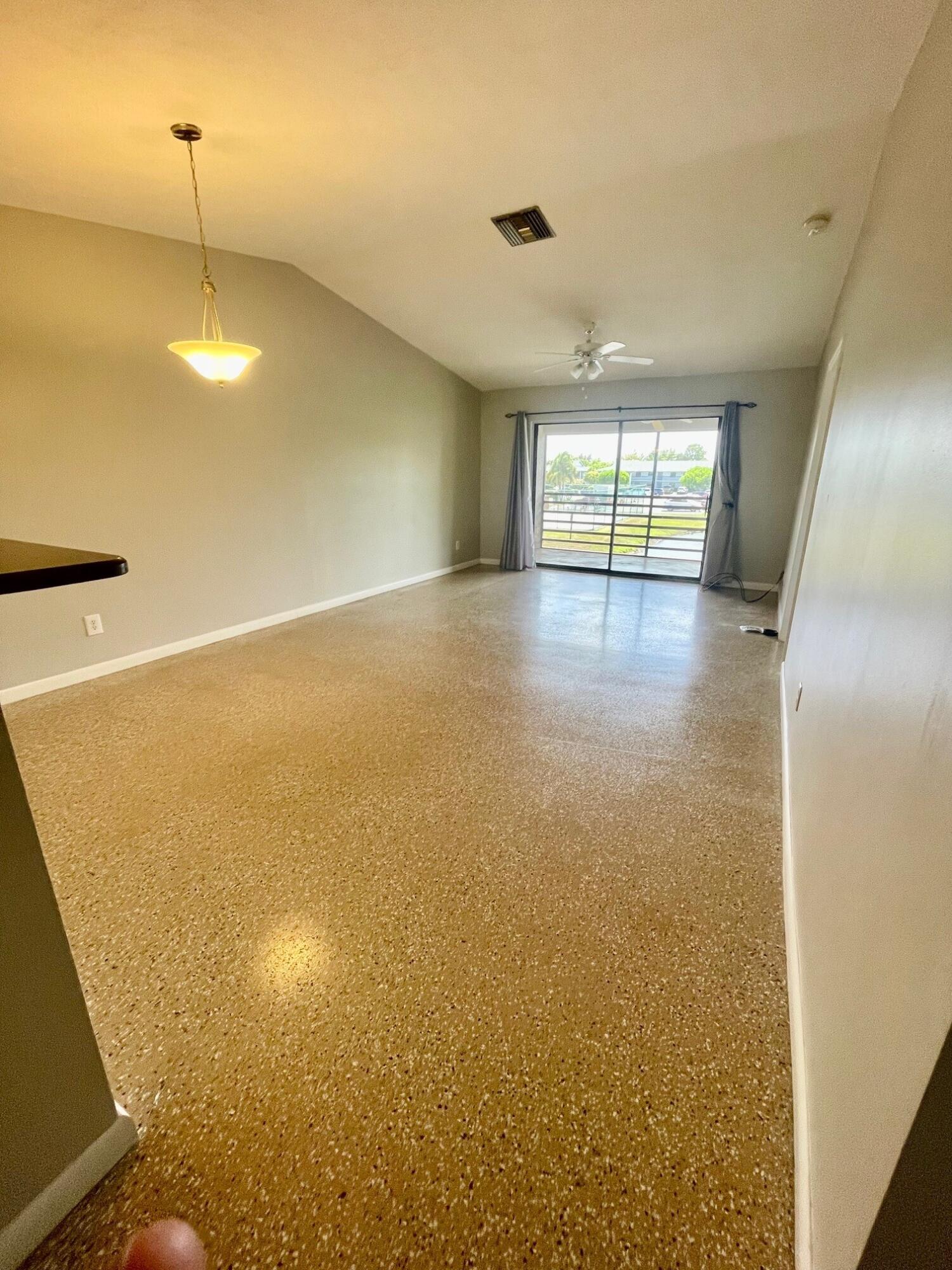 1271 Southeast Parkview Place, Unit H8 Stuart, FL 34994 - Photo 5 of 13 a view of an empty room with a window