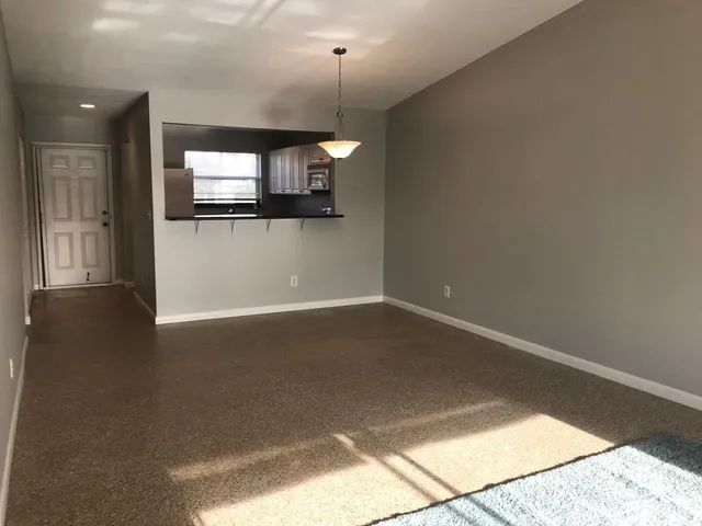 a view of a living room with wooden floor and flat screen tv