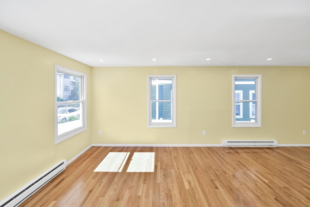 11 Greendale Road, Unit 2 Boston, MA 02126 - Photo 22 of 25 a view of an empty room with wooden floor and a window