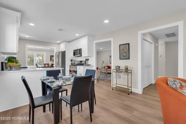 a view of a dining room with furniture and wooden floor