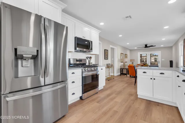 a kitchen with stainless steel appliances a refrigerator sink and microwave