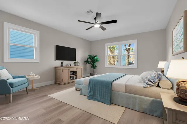 a spacious bedroom with a bed and a chandelier