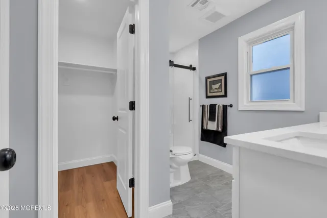 a bathroom with a sink vanity and mirror