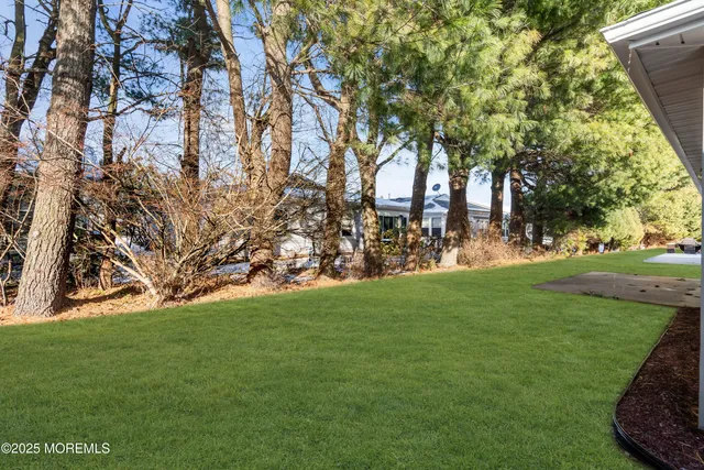 a view of a house with potted plants and a yard chair