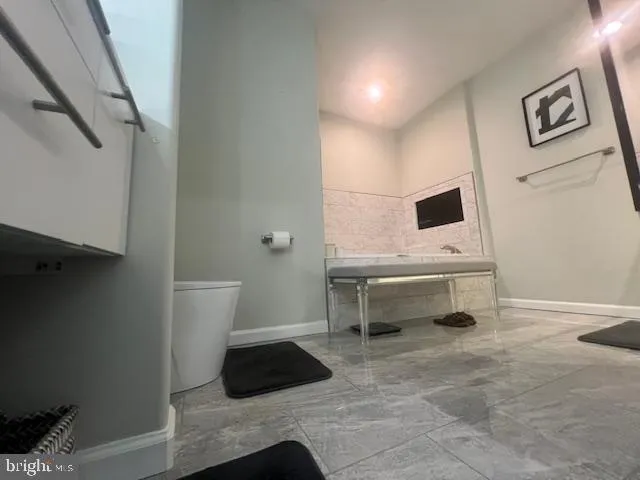 a kitchen with stainless steel appliances kitchen island granite countertop a stove a sink and a microwave