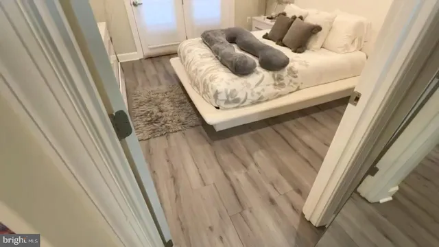 a white bath tub sitting next to a white toilet and a shower