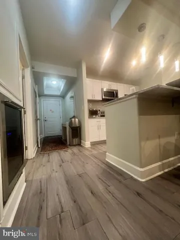 a bedroom with a bed lamp and a fireplace