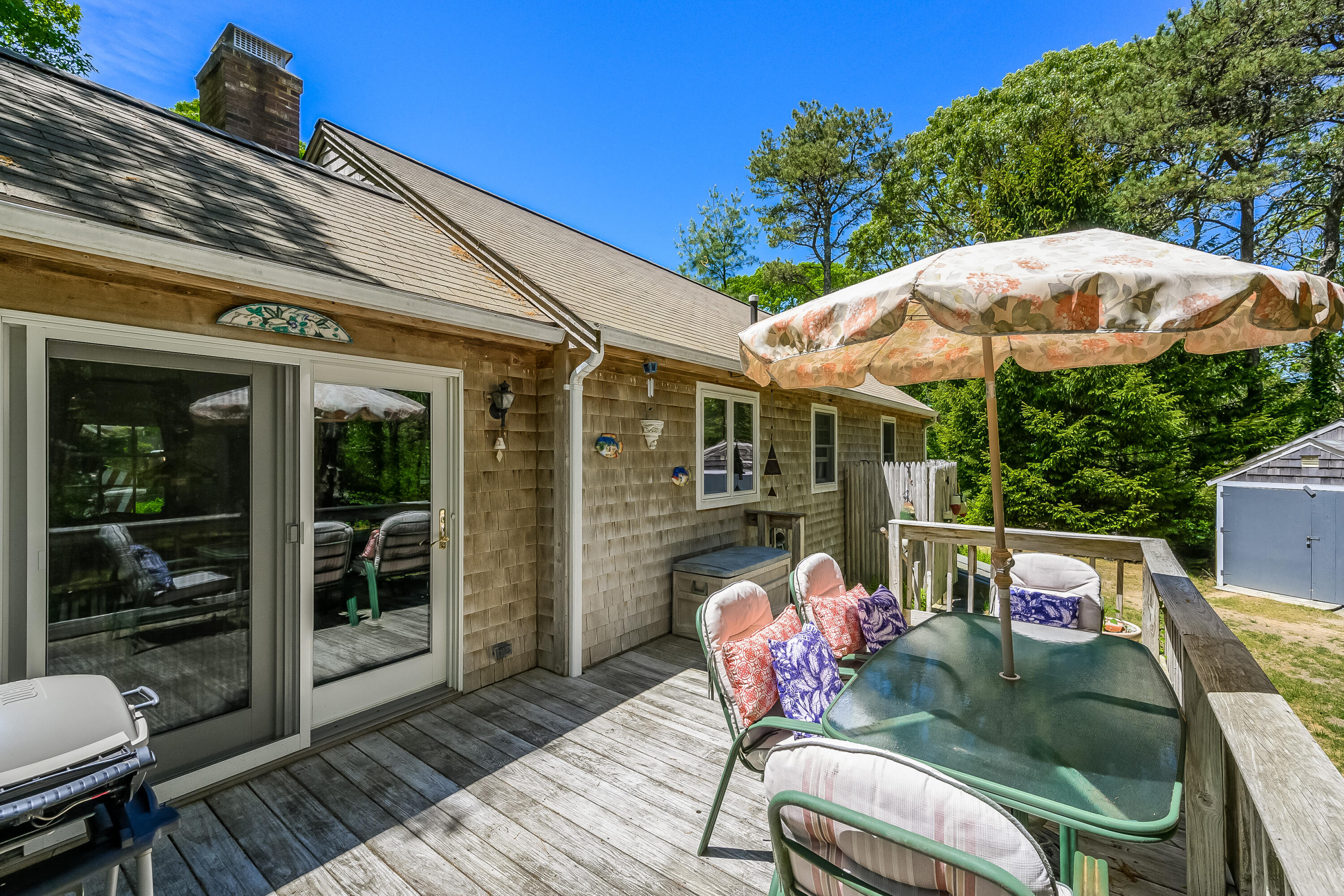 106 Tower Hill Circle Brewster, MA 02631 - Photo 15 of 19 a patio with wooden floor table and chairs