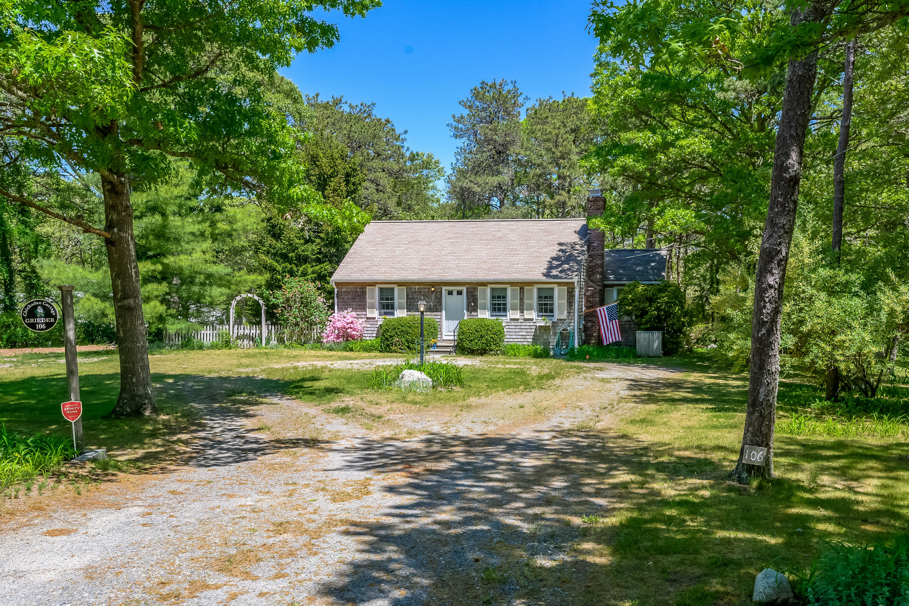 106 Tower Hill Circle Brewster, MA 02631 - Photo 3 of 19 a front view of a house with yard and green space