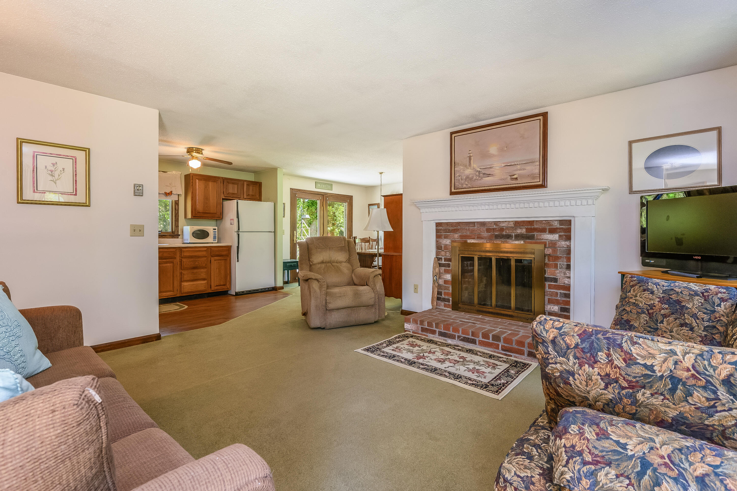 106 Tower Hill Circle Brewster, MA 02631 - Photo 6 of 19 a living room with furniture and a fireplace