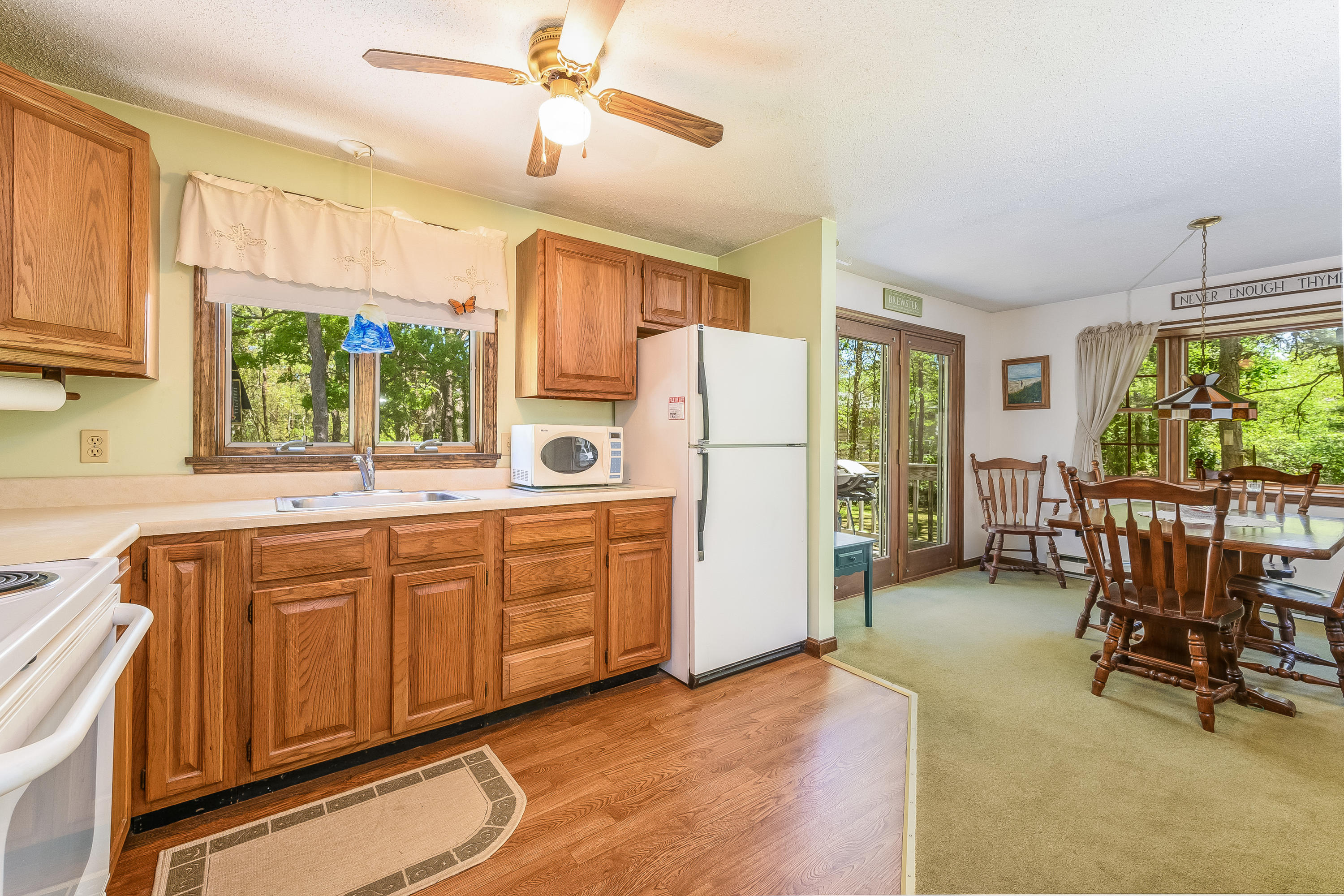 106 Tower Hill Circle Brewster, MA 02631 - Photo 7 of 19 a kitchen with refrigerator a sink and chairs