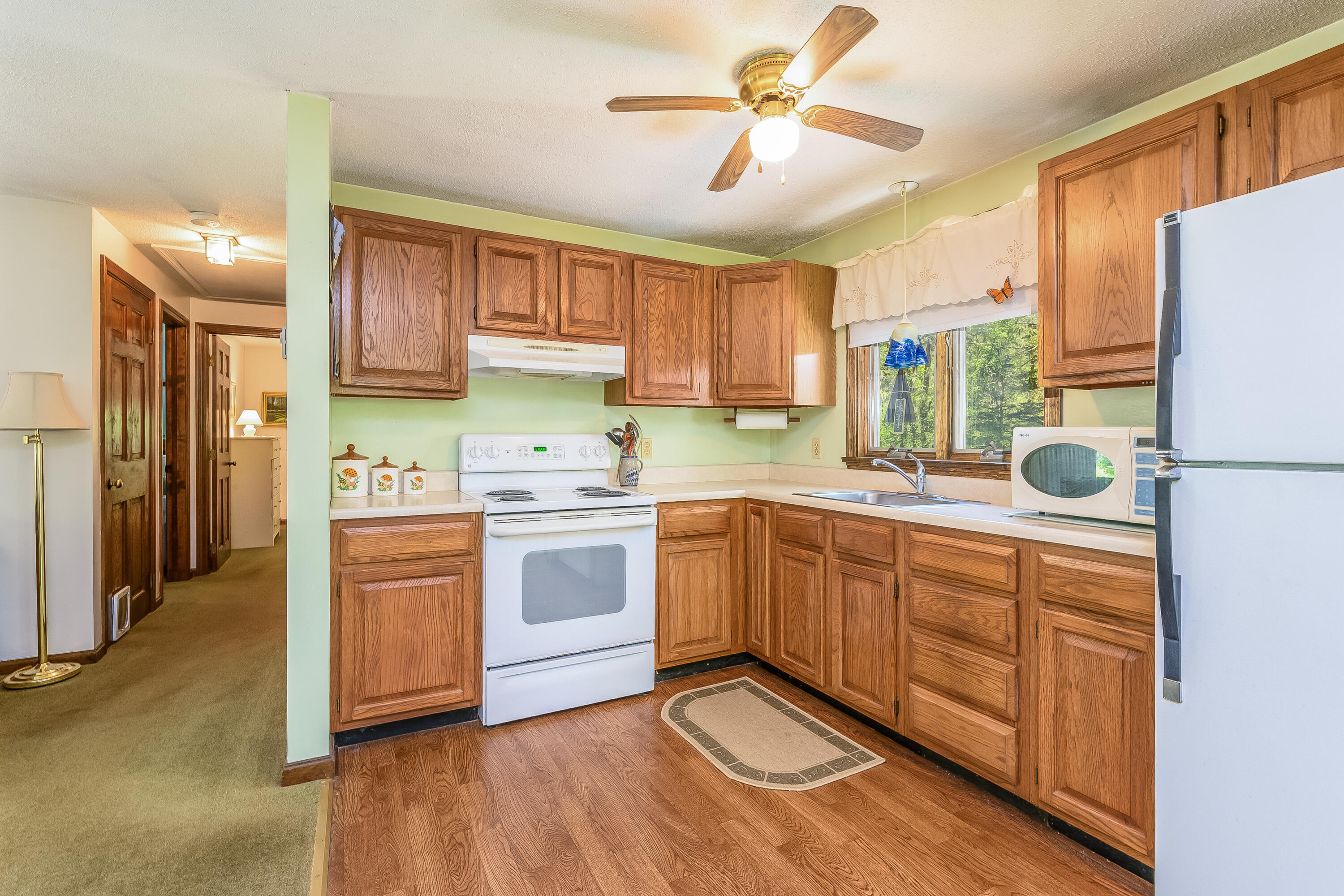 106 Tower Hill Circle Brewster, MA 02631 - Photo 8 of 19 a kitchen with a refrigerator sink and cabinets
