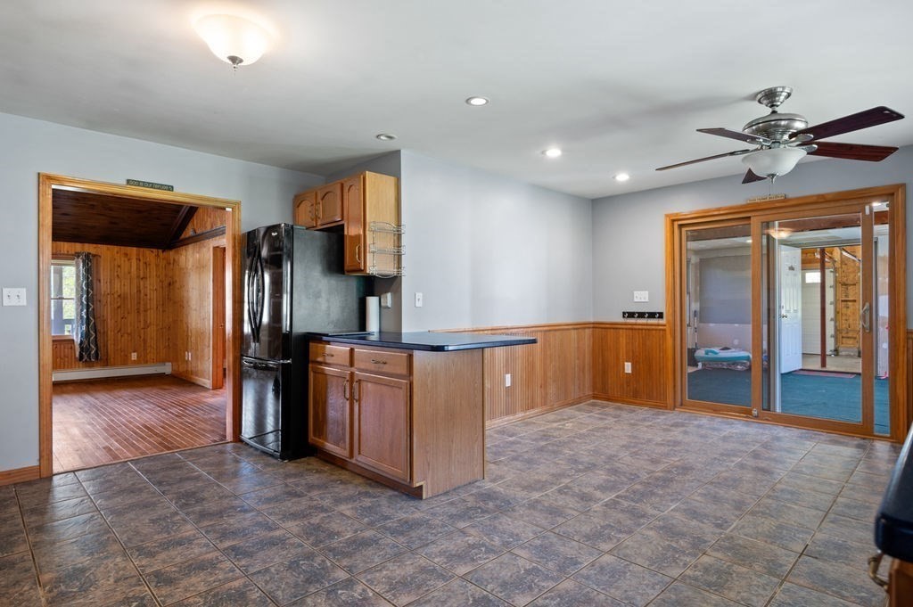 63 Middle Road Amesbury, MA 01913 - Photo 11 of 37 a view of kitchen with refrigerator cabinets and outdoor view