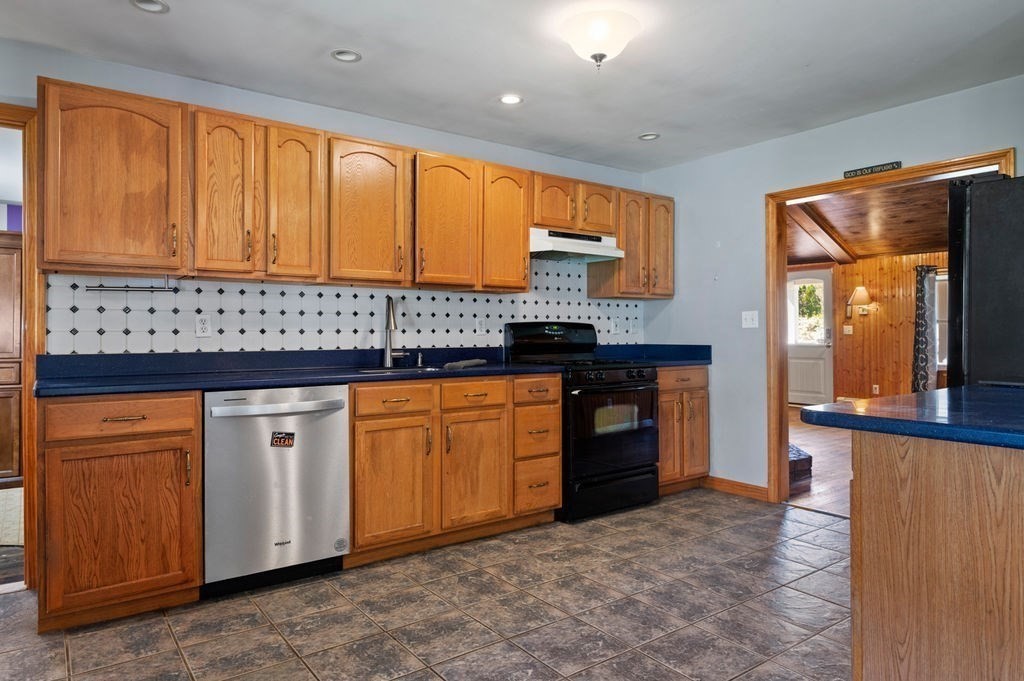 63 Middle Road Amesbury, MA 01913 - Photo 13 of 37 a kitchen with stainless steel appliances granite countertop a stove a sink and a refrigerator
