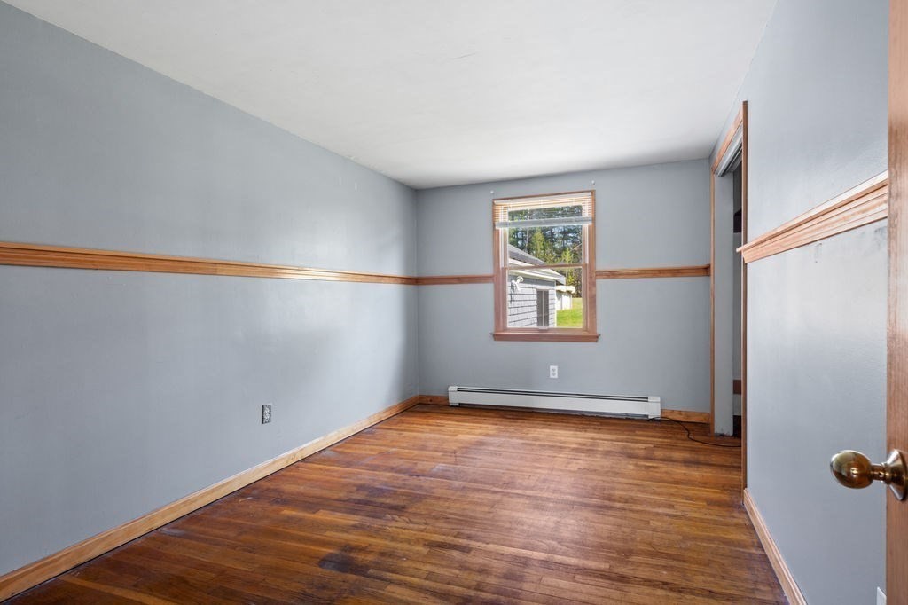 63 Middle Road Amesbury, MA 01913 - Photo 17 of 37 an empty room with wooden floor and windows