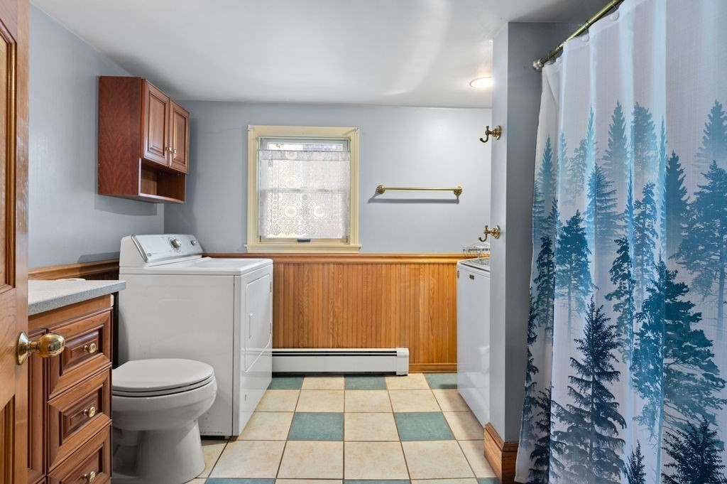63 Middle Road Amesbury, MA 01913 - Photo 20 of 37 a bathroom with a sink a toilet a window and a shower