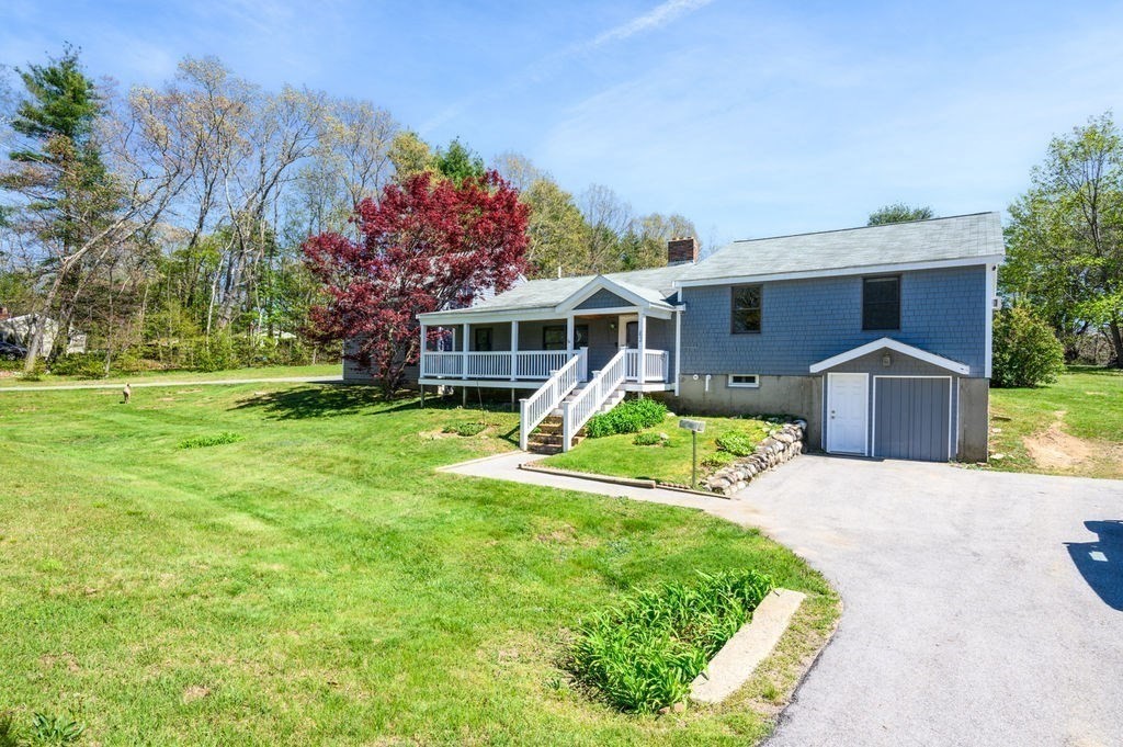 63 Middle Road Amesbury, MA 01913 - Photo 2 of 37 a front view of a house with a yard and potted plants