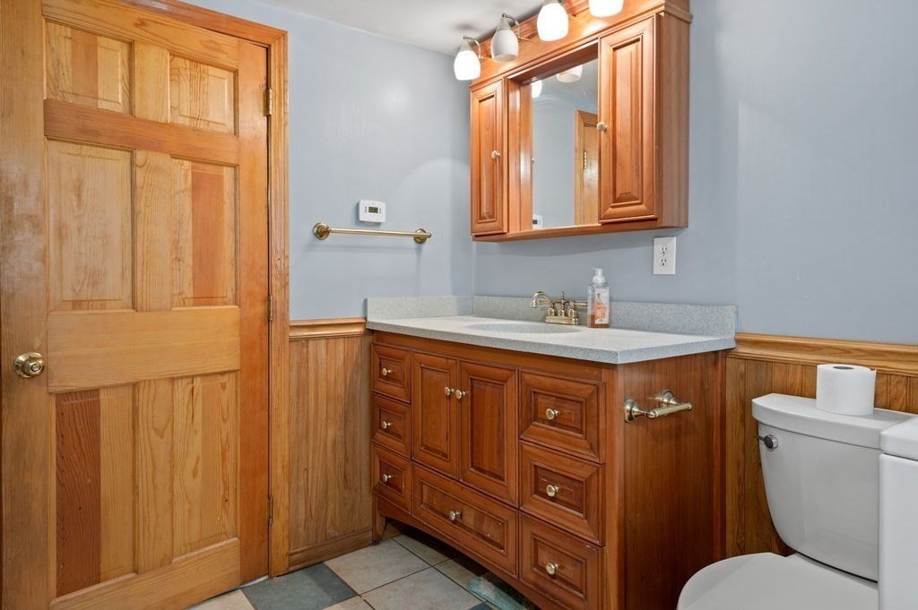 63 Middle Road Amesbury, MA 01913 - Photo 21 of 37 a bathroom with a granite countertop toilet sink and mirror