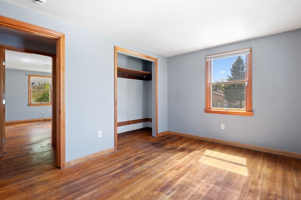63 Middle Road Amesbury, MA 01913 - Photo 22 of 37 a view of an empty room with wooden floor and a window