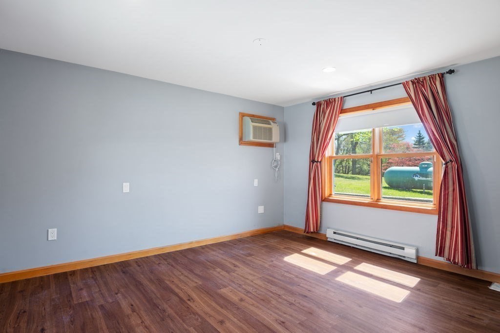 63 Middle Road Amesbury, MA 01913 - Photo 26 of 37 an empty room with wooden floor and windows