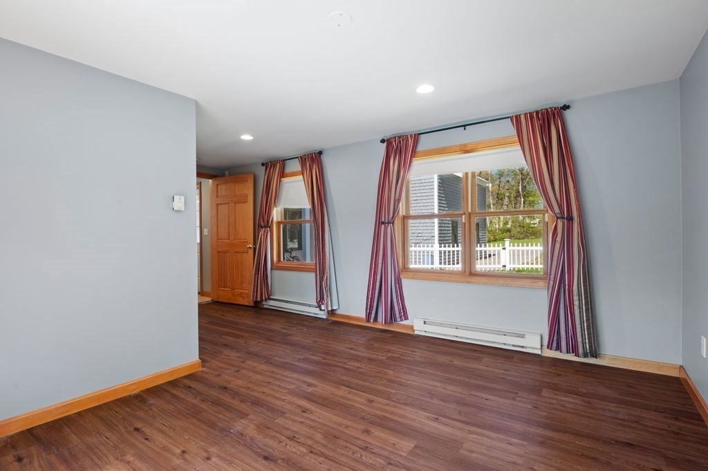 63 Middle Road Amesbury, MA 01913 - Photo 27 of 37 an empty room with wooden floor and windows