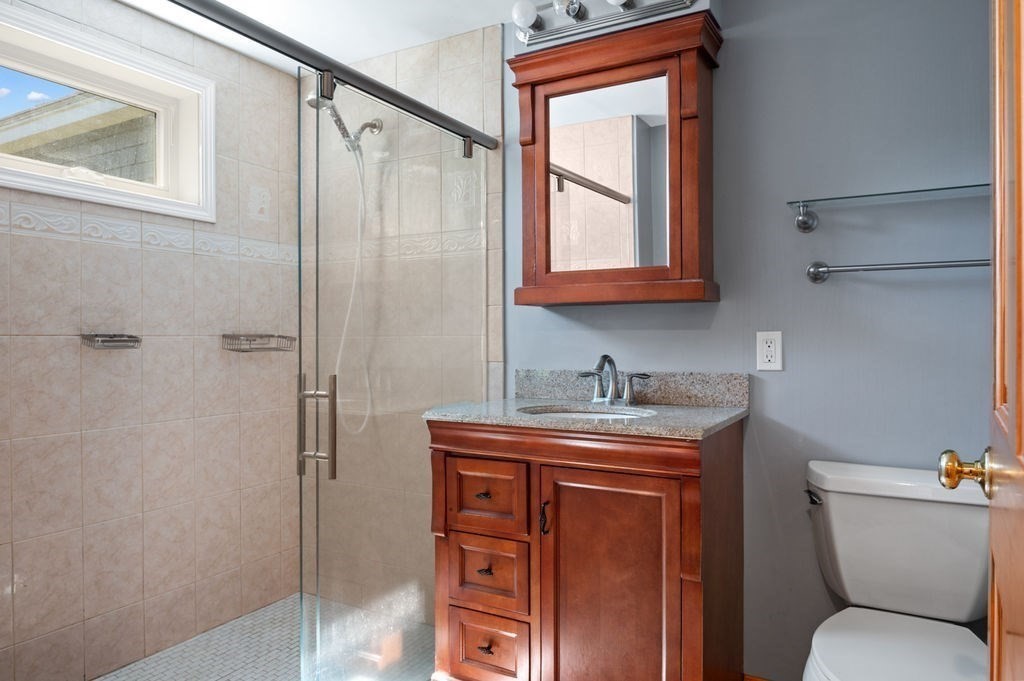 63 Middle Road Amesbury, MA 01913 - Photo 28 of 37 a bathroom with a granite countertop toilet sink and mirror