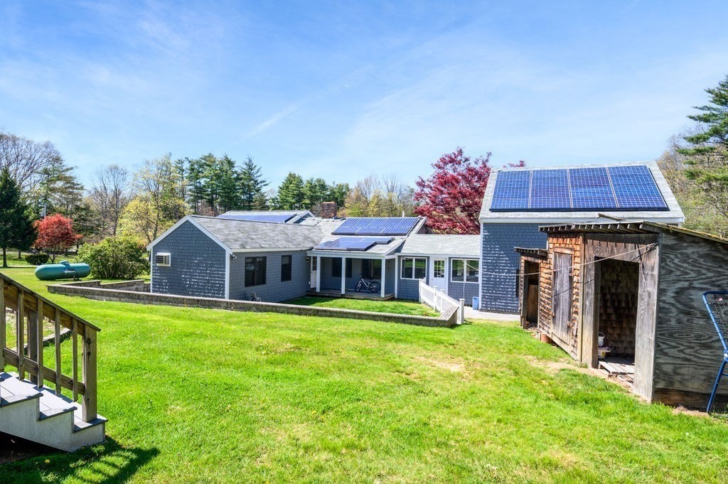 63 Middle Road Amesbury, MA 01913 - Photo 35 of 37 a view of a house with a yard table and chairs