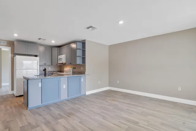 a kitchen with stainless steel appliances granite countertop a refrigerator sink and cabinets