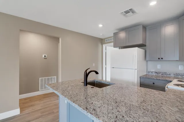 a kitchen with a sink and a refrigerator