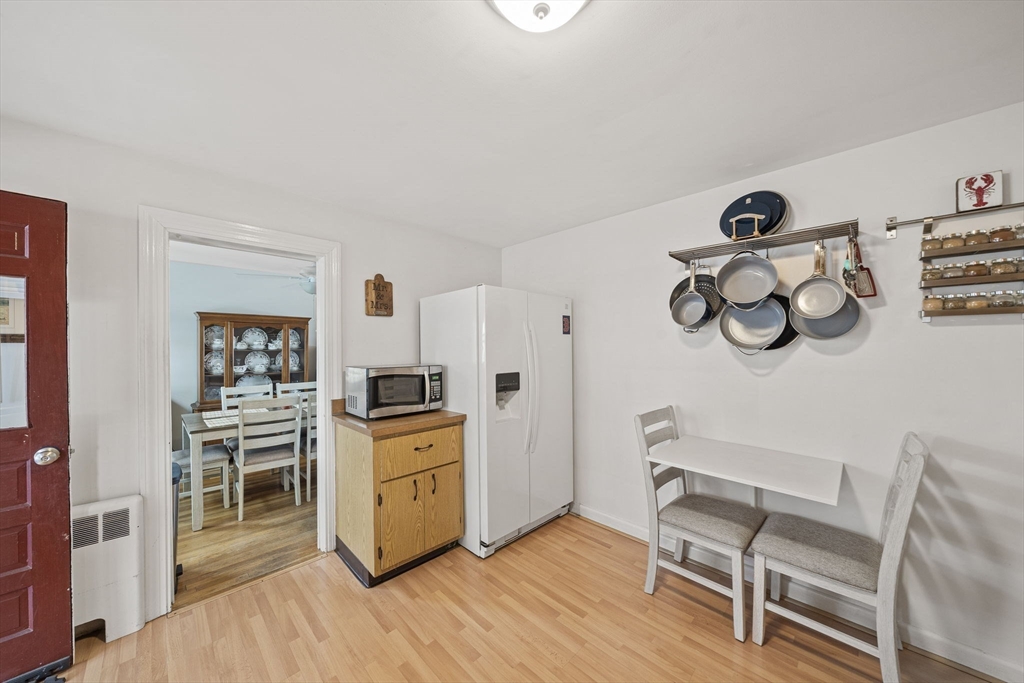15 D Street Hull, MA 02045 - Photo 40 of 42 a kitchen with a stove a refrigerator and wooden floor