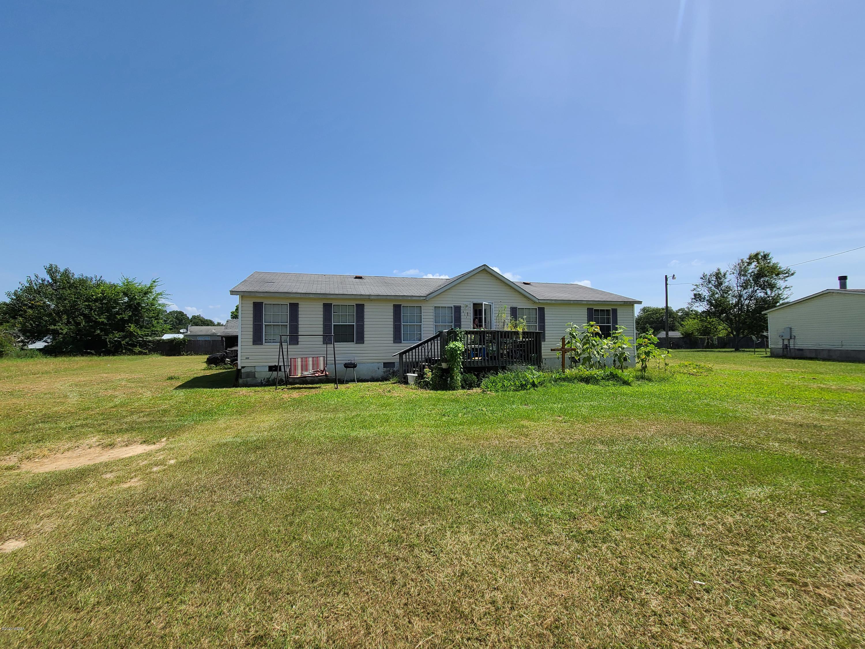 512 Boy Scout Road Byron, GA 31008 - Photo 1 of 12 a front view of a house with garden