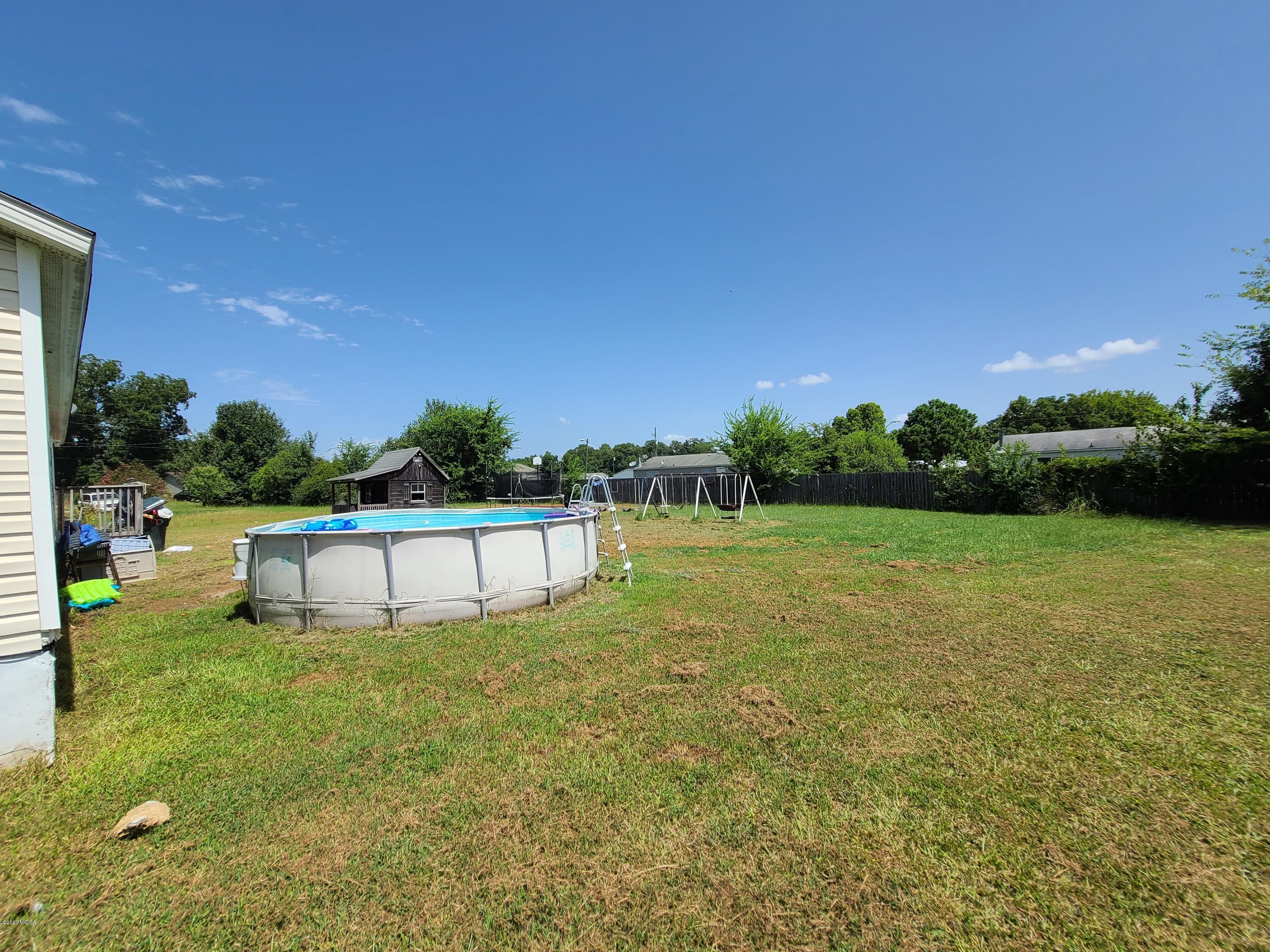 512 Boy Scout Road Byron, GA 31008 - Photo 8 of 12 a view of a green field with house in background