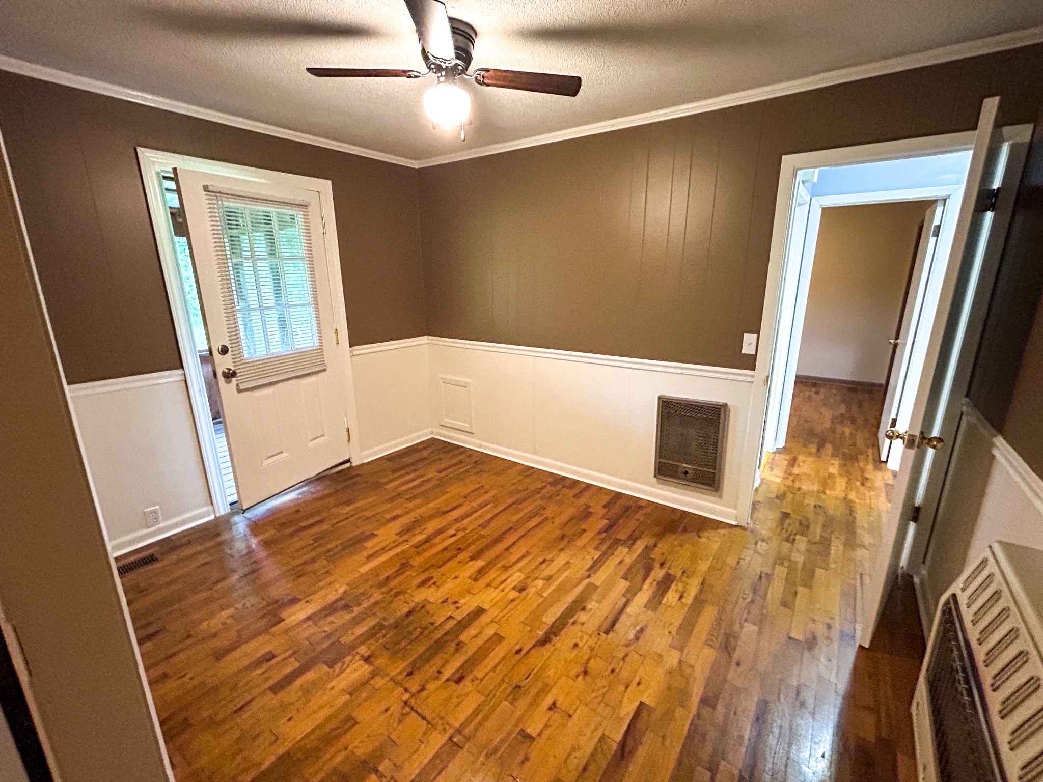 181 Jones Street Huntingdon, TN 38344 - Photo 13 of 21 an empty room with wooden floor and windows