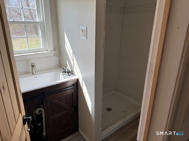 605 Highway 6 Andover, CT 06232 - Photo 11 of 14 a bathroom with a sink a mirror and a shower