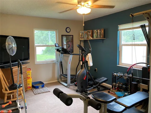 a room with gym equipment and windows