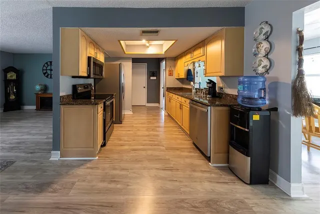 a kitchen with stainless steel appliances granite countertop a stove and a refrigerator