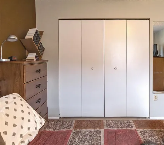 a view of a bedroom with wooden floor