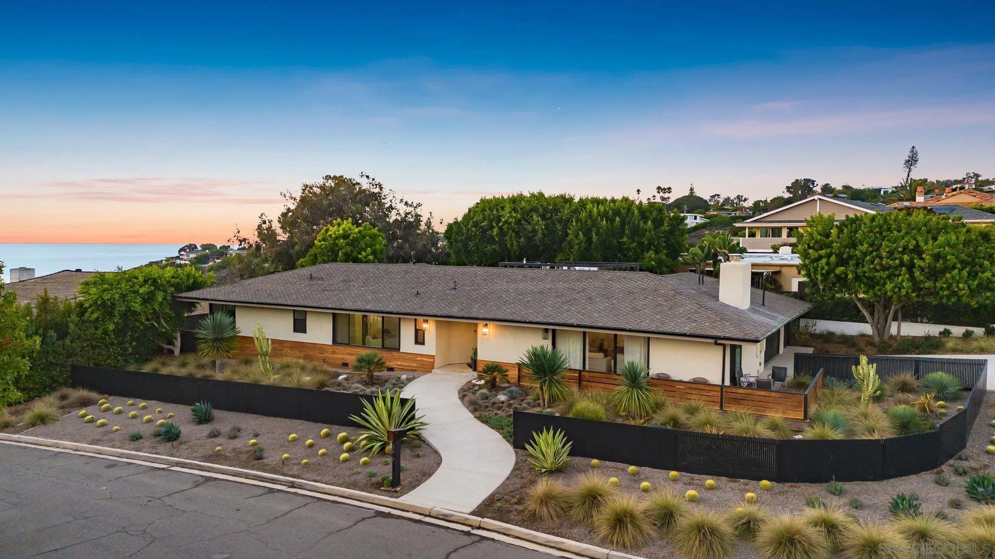 an aerial view of a house with swimming pool garden and patio