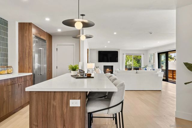 a kitchen with kitchen island a dining table and chairs