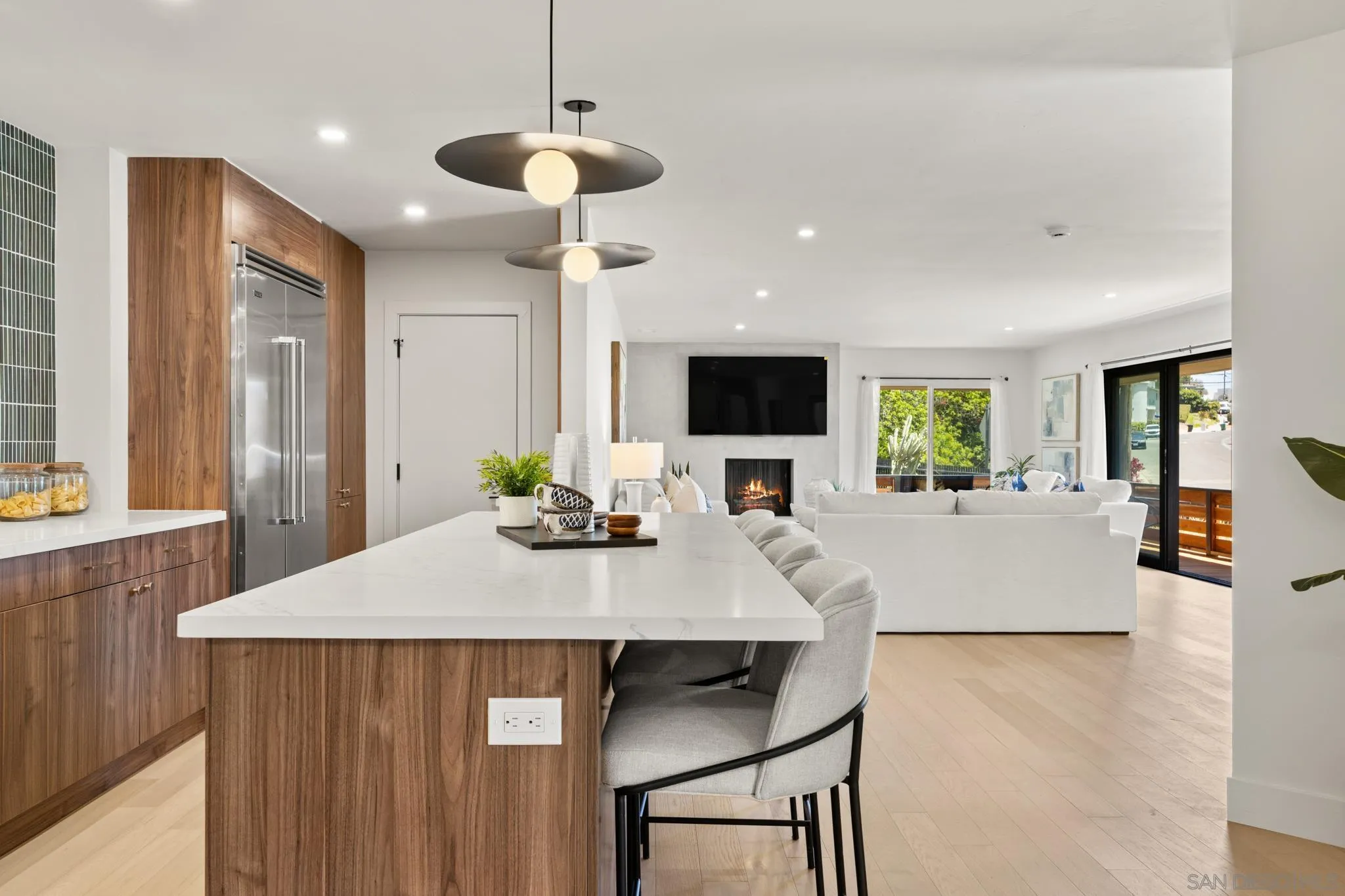 896 La Jolla Rancho Road La Jolla, CA 92037 - Photo 11 of 54 a kitchen with kitchen island a dining table and chairs