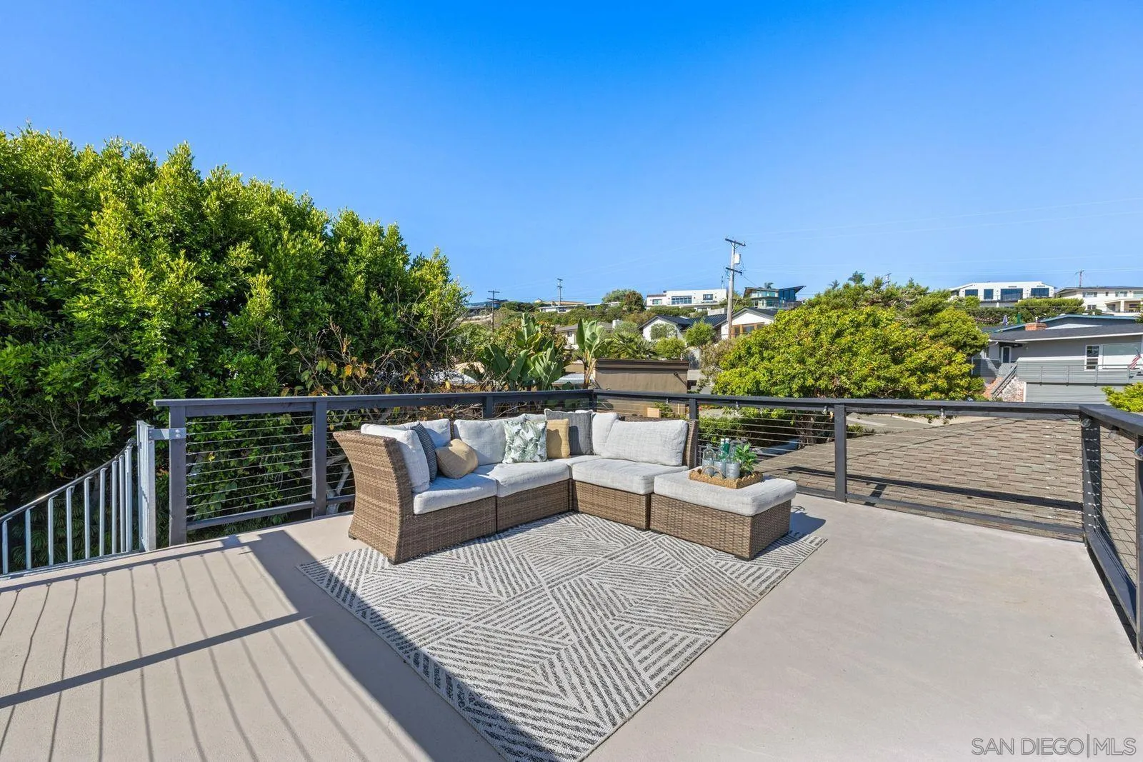 896 La Jolla Rancho Road La Jolla, CA 92037 - Photo 18 of 54 a roof deck with couches and wooden floor