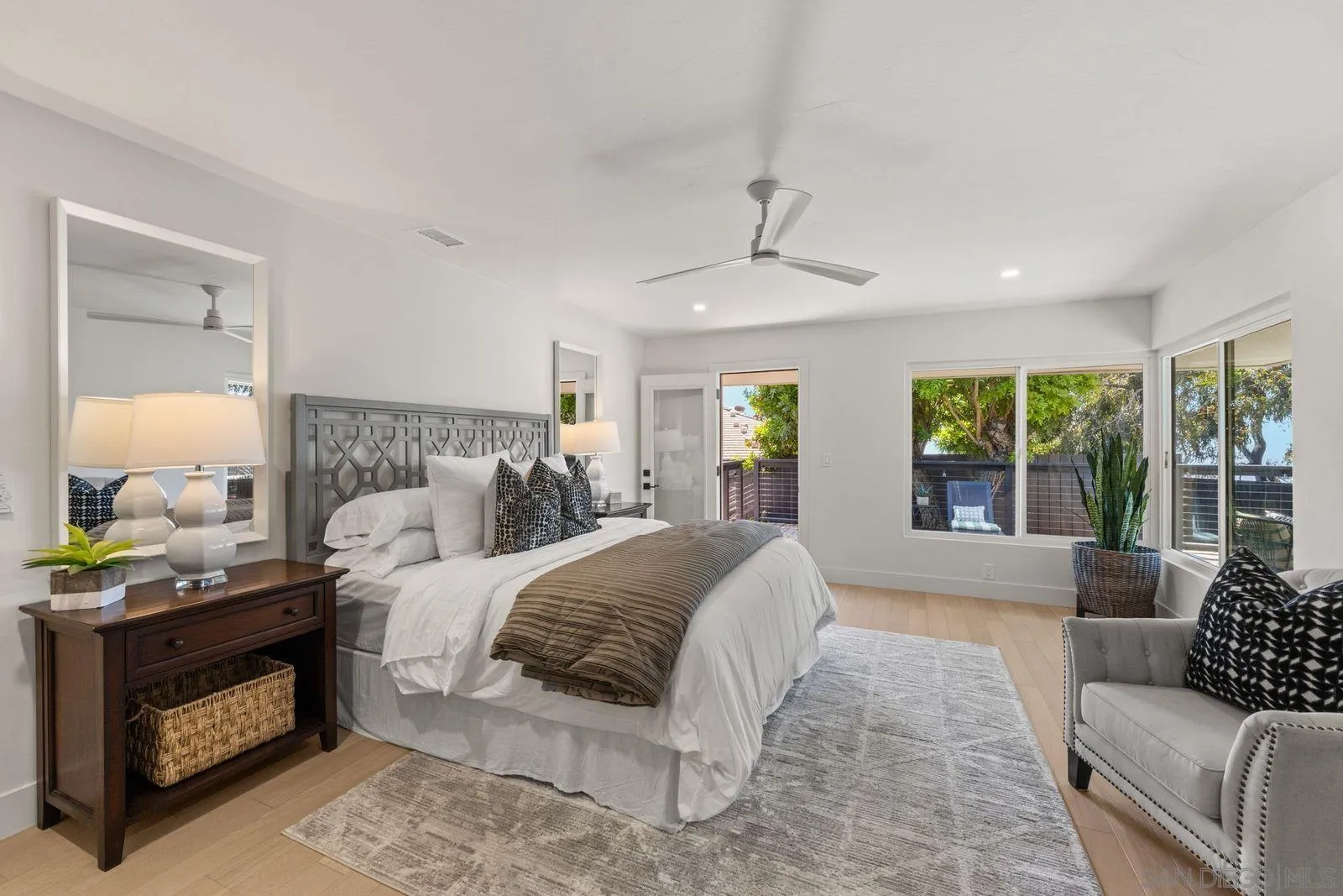 896 La Jolla Rancho Road La Jolla, CA 92037 - Photo 24 of 54 a spacious bedroom with a bed and a couch