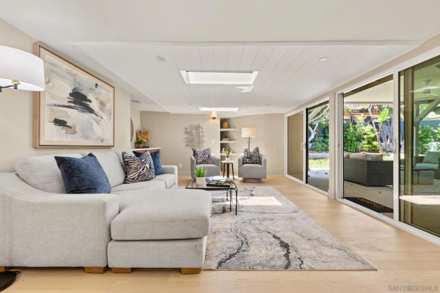 a living room with furniture and large window