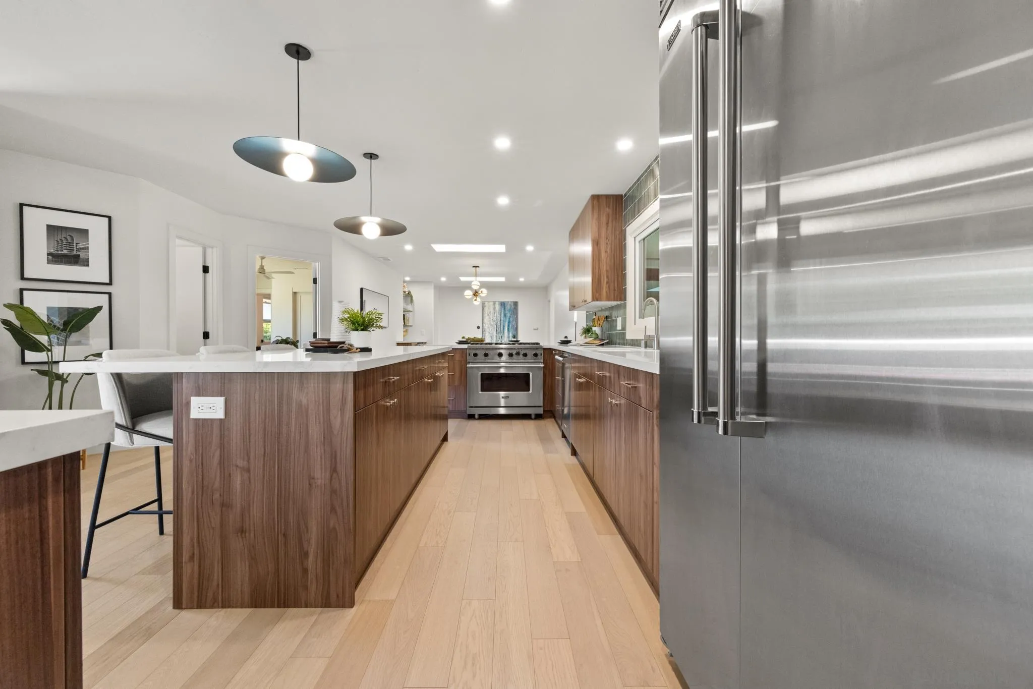 896 La Jolla Rancho Road La Jolla, CA 92037 - Photo 36 of 54 a kitchen with stainless steel appliances kitchen island granite countertop a table chairs and a refrigerator