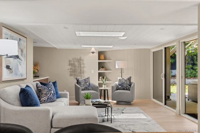 a kitchen with a sink and chairs