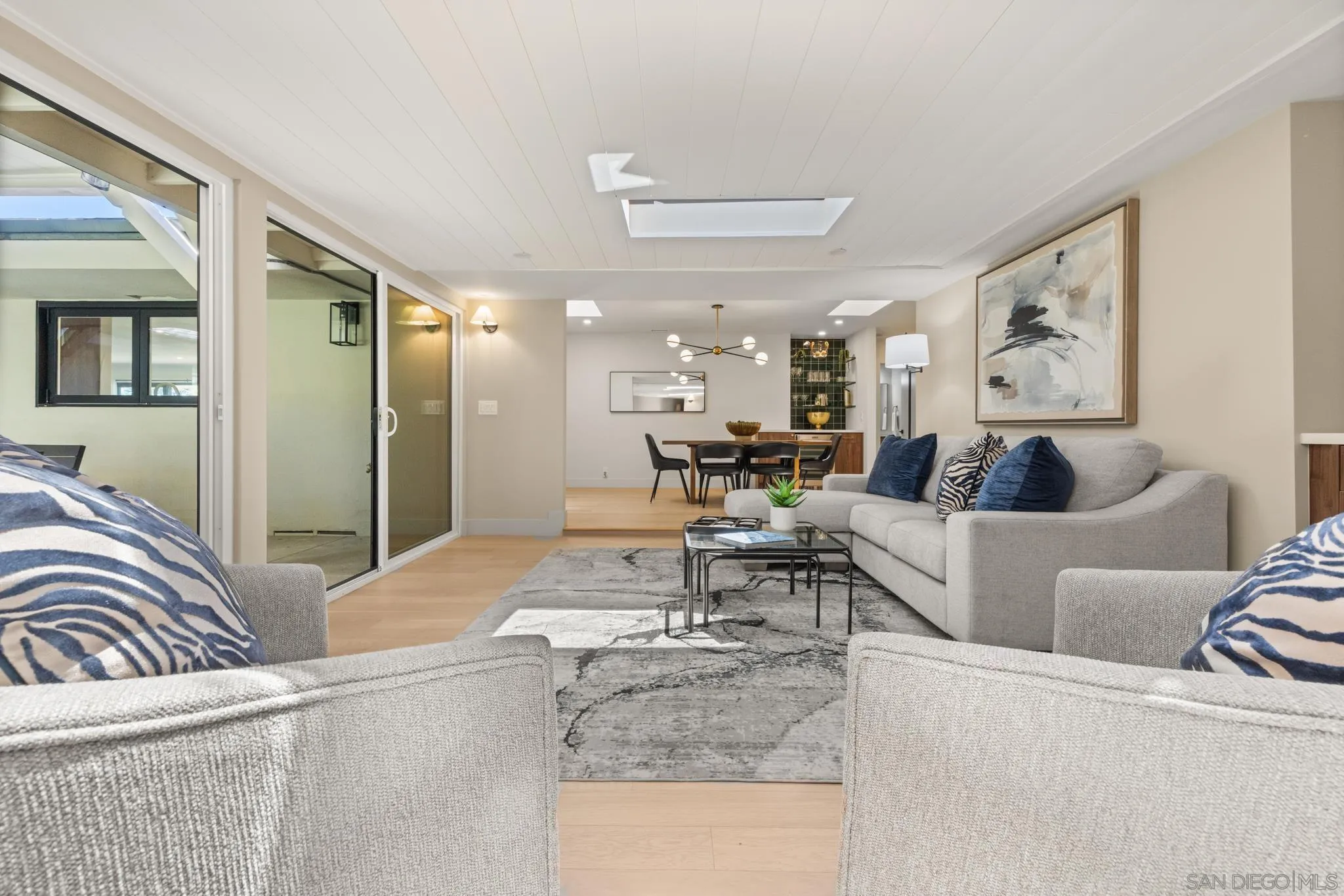 896 La Jolla Rancho Road La Jolla, CA 92037 - Photo 43 of 54 a living room with furniture and a dining table